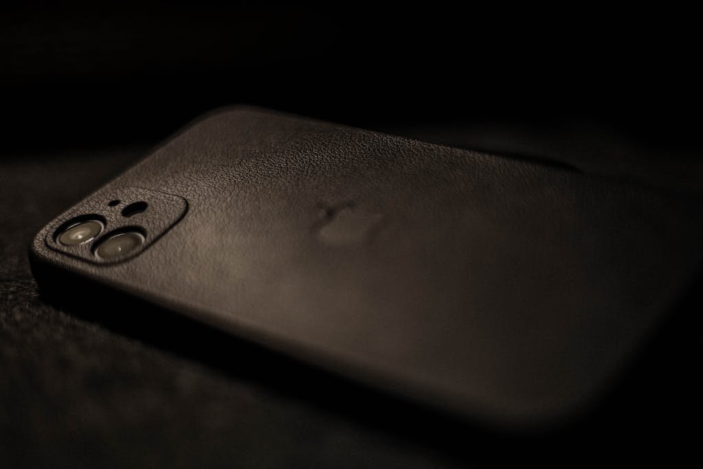 Detailed view highlighting a smartphone with a sleek black case, emphasizing elegance and modern design.